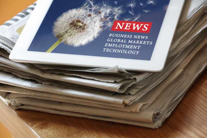 Digital tablet on newspaper Mainstay Company